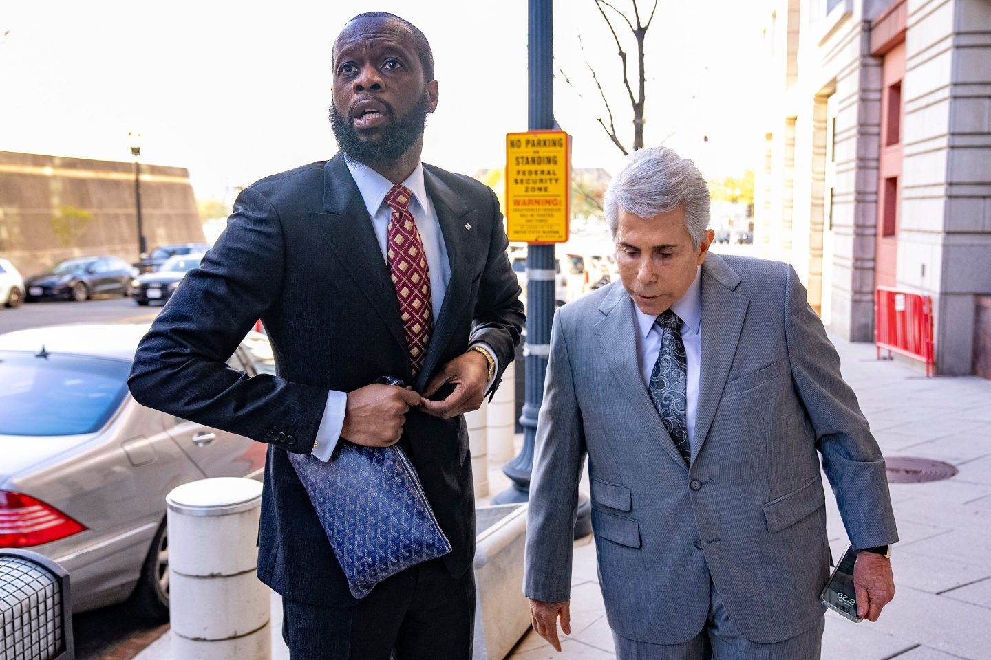 Prakazrel "Pras" Michel, a member of the 1990s hip-hop group the Fugees, accompanied by defense lawyer David Kenner, right, arrives at federal court in Washington in April 2023.