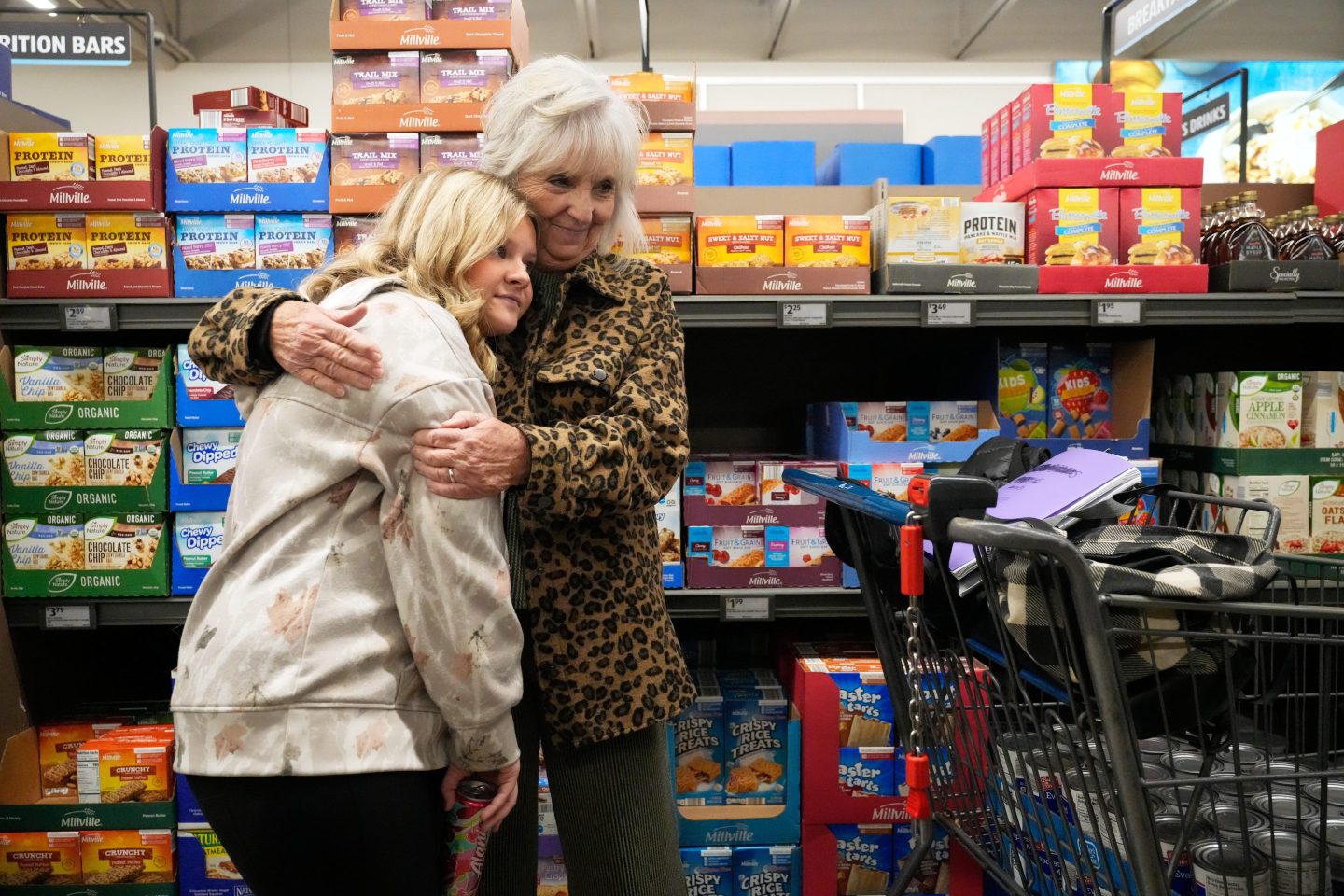 High school cafeteria worker Shirley Mease, right, stops to hug her granddaughter Teagan Porter as they shop for supplies to prepare 700 free Thanksgiving meals for community members in Missouri on Tuesday.