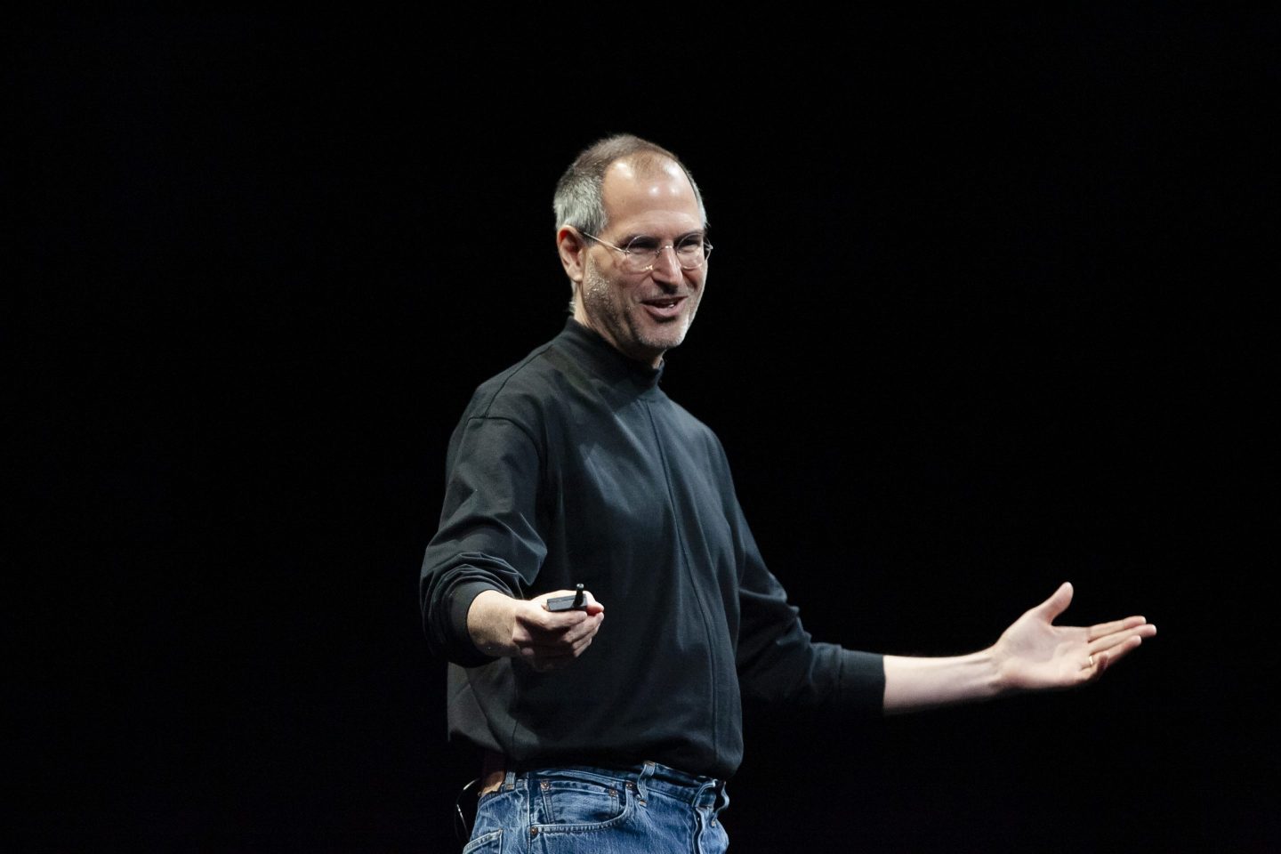 Steve Jobs giving an Apple presentation in his iconic black turtleneck
