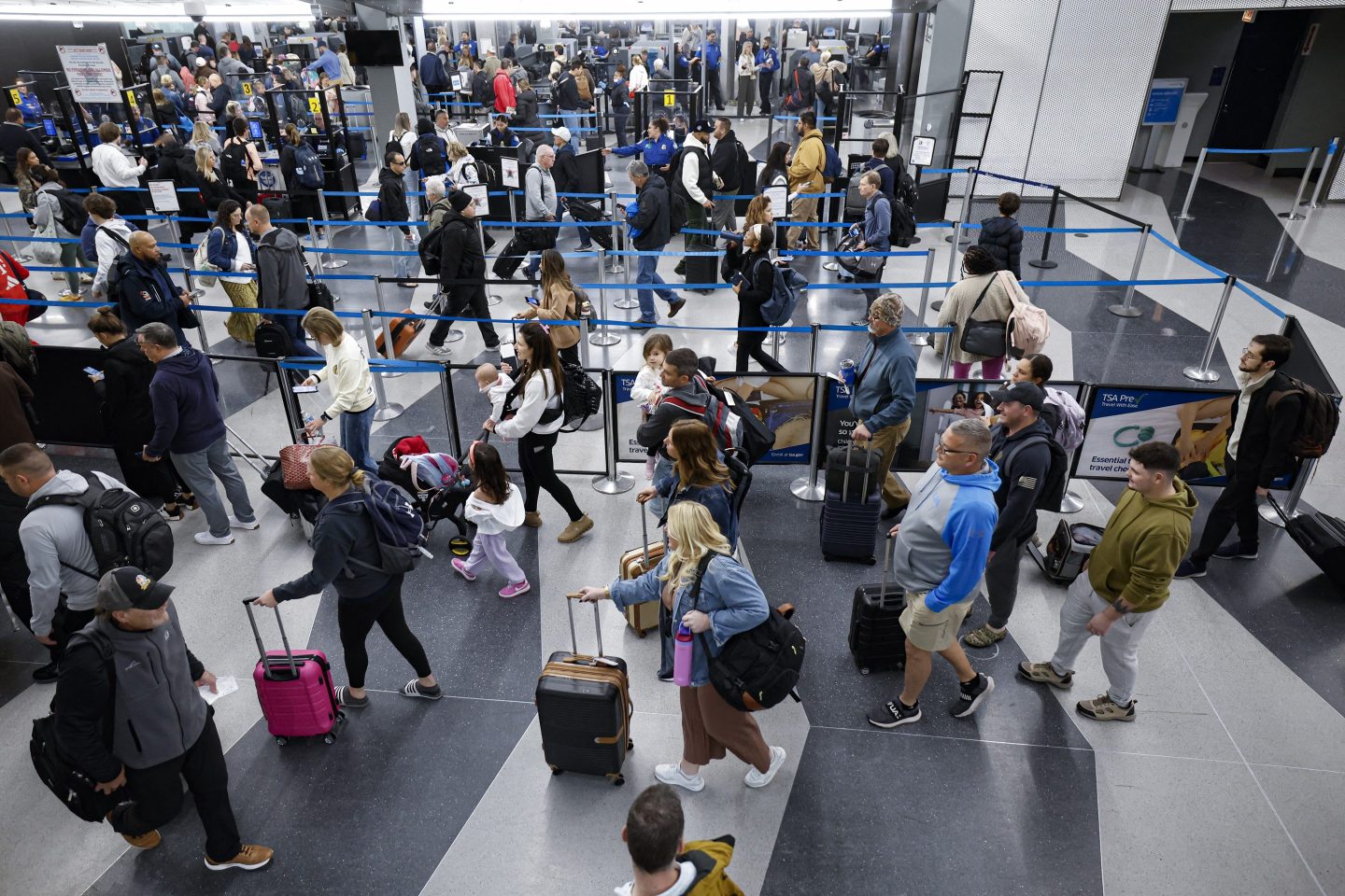 Travelers line up at the security checkpoint at O'Hare International Airport in Chicago, Illinois, on November 22, 2024, ahead of the upcoming Thanksgiving holiday.