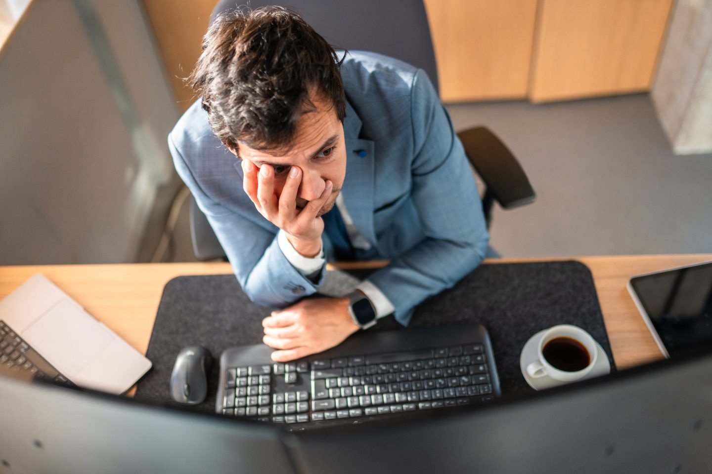 A pessimistic looking male worker at his desk