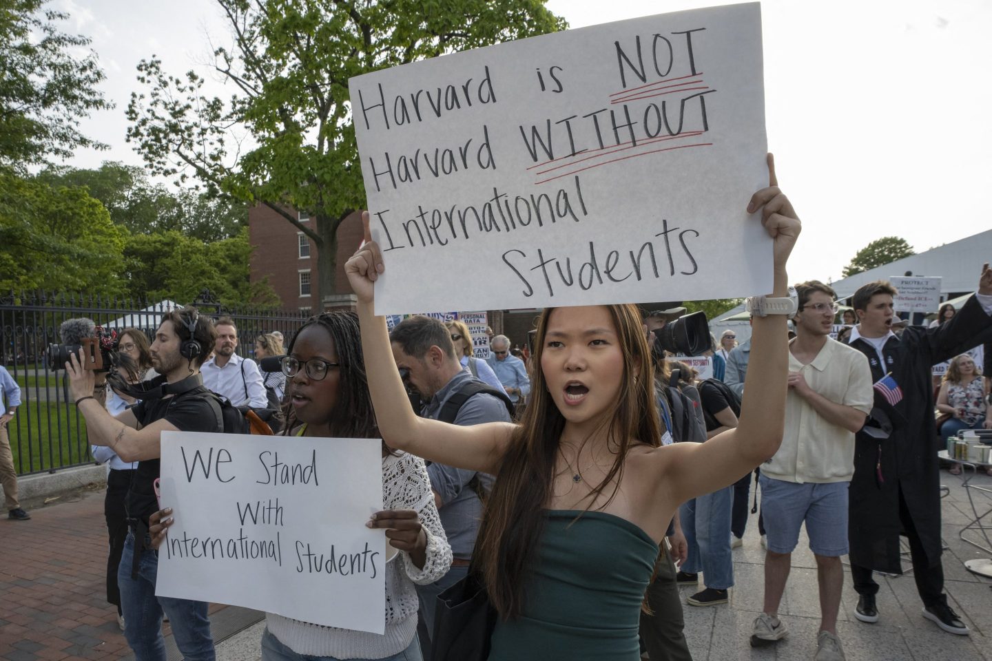 People hold up signs during the Harvard Students for Freedom rally in support of international students at the Harvard University campus in Boston, Massachusetts, on May 27, 2025.