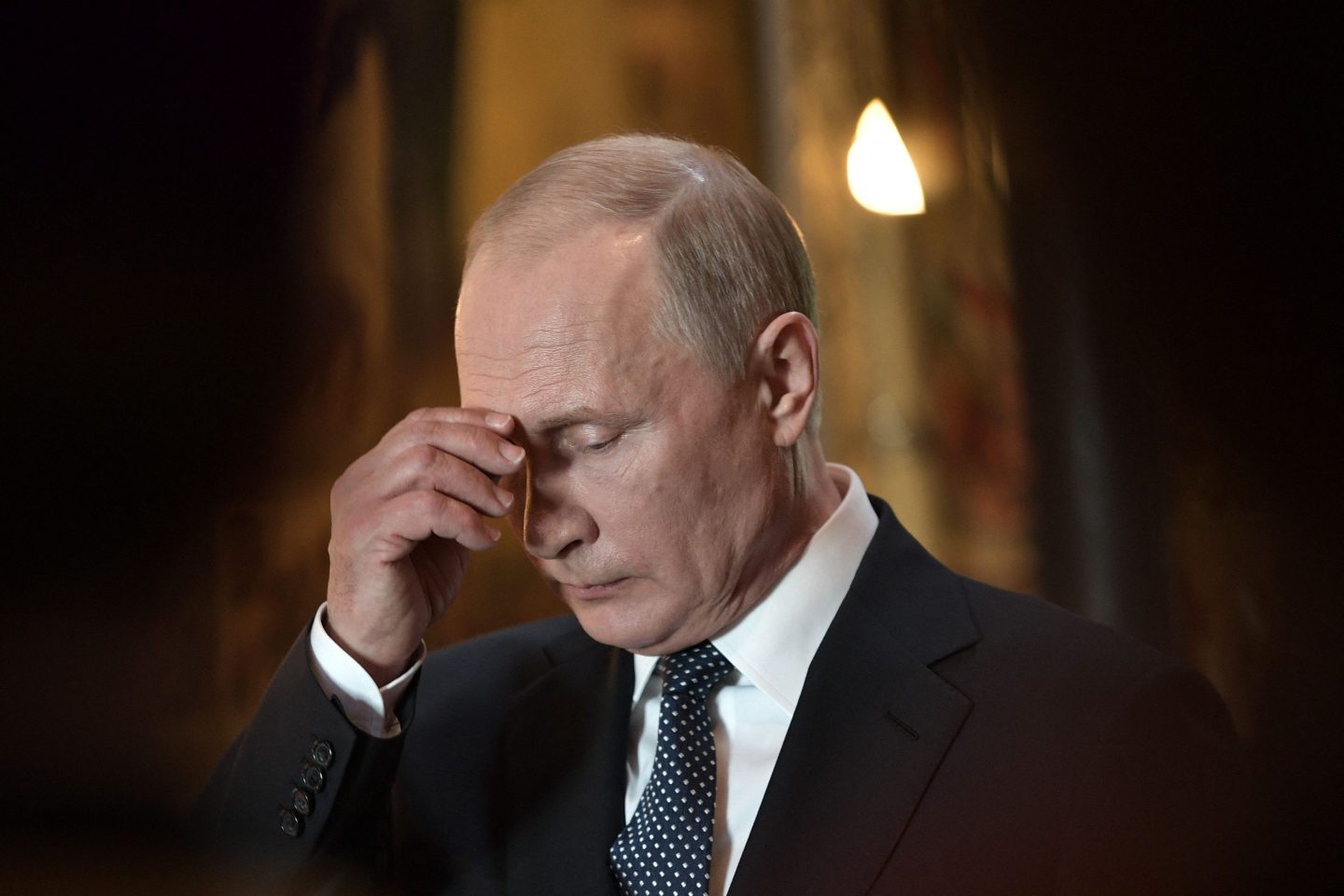Vladimir Putin hides his face